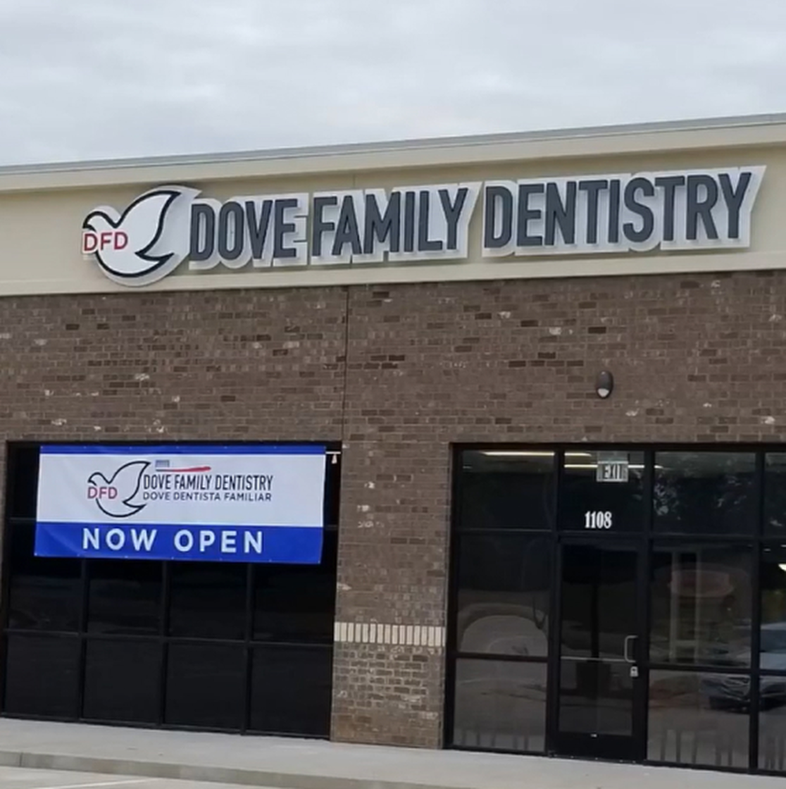 Dove Family Dentistry storefront with "Now Open" sign on brick building exterior.