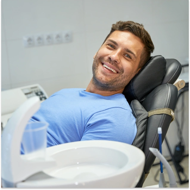 Smiling man relaxed in dental chair at professional dentistry office