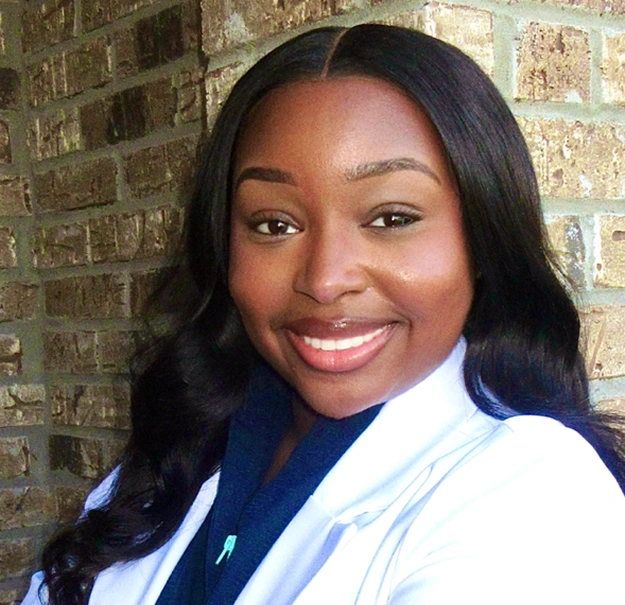 Dr. Davis, dentist at Memphis dental practice, smiling in professional white coat.