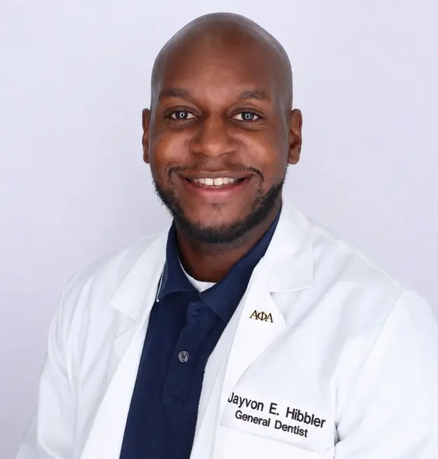 Dr. Jayvon F. Hibbler, General Dentist, smiles in professional portrait wearing white coat.